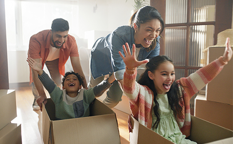 New family playing with moving boxes.